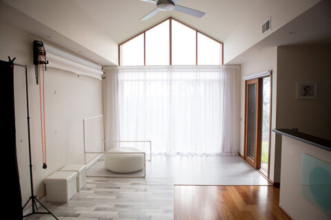 Light-filled newborn photography studio in Beaconsfield with a high gabled window