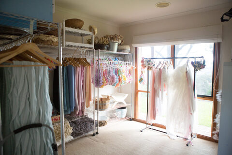 Studio wardrobe stocked with newborn wraps, outfits and props