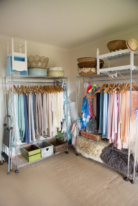 Studio wardrobe racks filled with newborn wraps and outfits